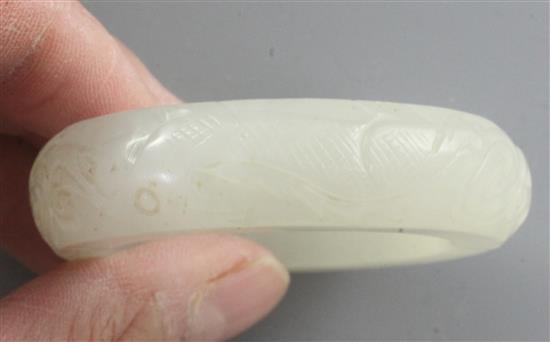 A Chinese white jade bangle or ring, diameter 5.7cm